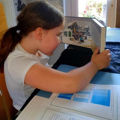 Photos of our pupils enjoying their reading outside of school